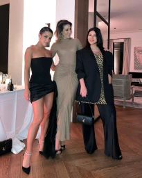 Three women posing together indoors wearing elegant evening attire in Sydney, captured by Martha Kalifatidis.
