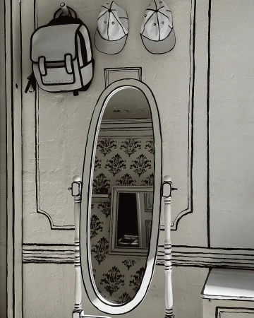 Mirror and wall art featuring a cartoon-style backpack and caps hanging above the standing mirror in a white-and-black interior setting.