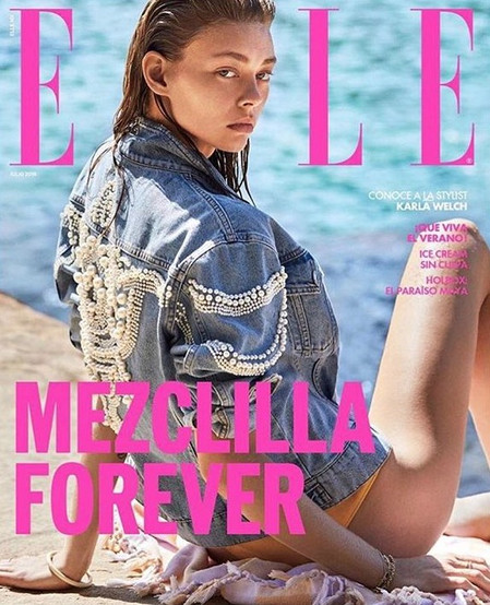 Elle magazine cover featuring a young woman in a denim jacket with pearl embellishments on a beach with the text 'Mezclilla Forever'.