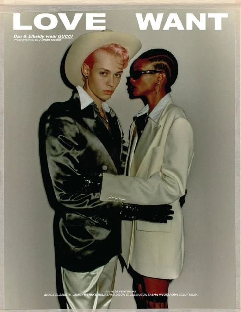 Editorial fashion shot of two models wearing Gucci blazers, gloves, and cowboy hat in a photo studio with dramatic lighting and text.