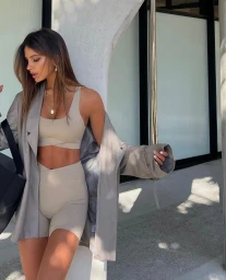 Woman in beige activewear set and oversized blazer posing outdoors in Sydney by Olivia Grivas