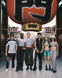 Group of six diverse young people posing beneath a giant red lantern in Sydney shot by Onyedika Agbarakwe