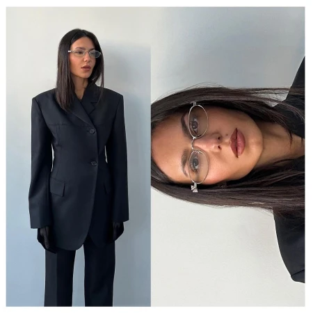Woman wearing a black blazer and oval glasses in a diptych format against a plain light wall
