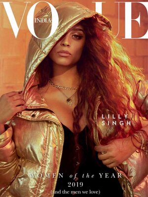 Magazine cover featuring Lilly Singh wearing a gold puffer jacket with a hood, and jewelry against an orange and brown background.