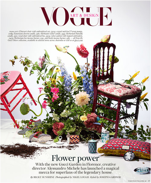Vogue magazine cover featuring floral arrangement and ornate chairs in pink and burgundy, set against a bright white background.