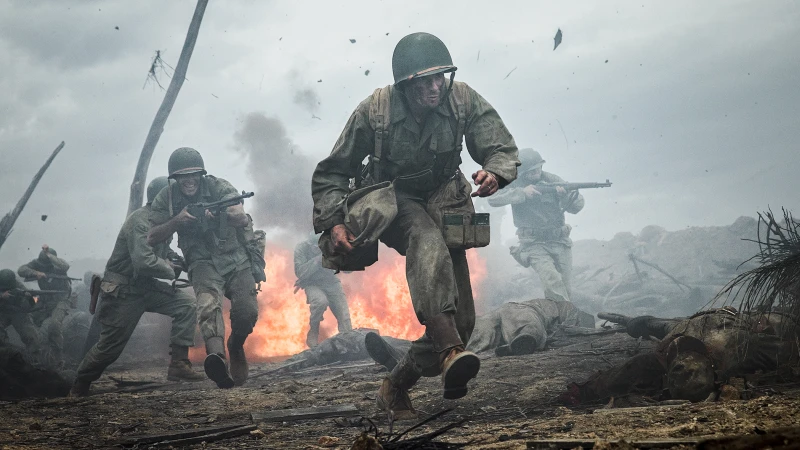 Dramatic scene of soldiers in helmets and military uniforms running and holding weapons amidst smoke and fire during battle.
