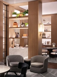 Modern interior styled by Simone Haag featuring textured armchairs, wooden shelving, and warm built-in lighting in Sydney.