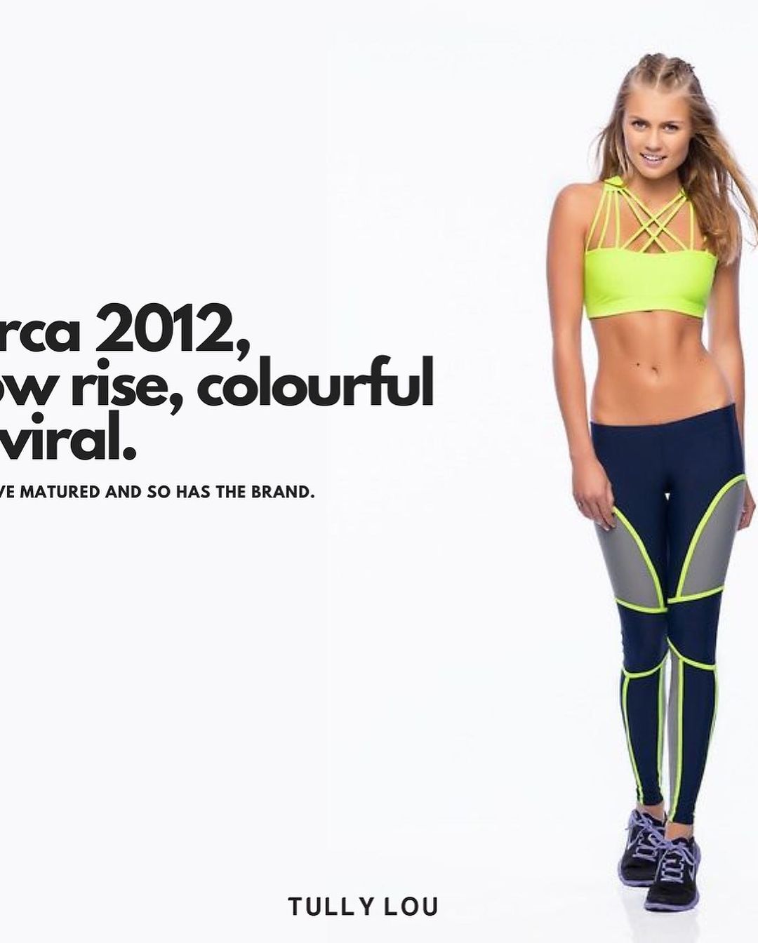 A young woman in athletic wear poses in front of a white backdrop. She wears a yellow sports bra and blue leggings with gray panels.