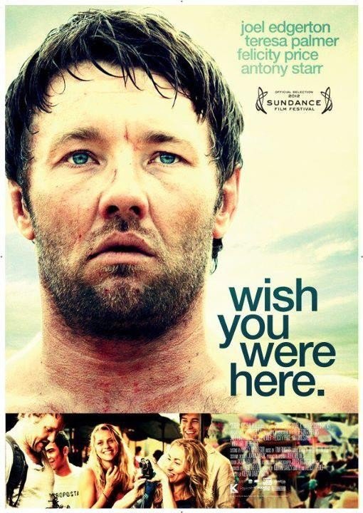 Movie poster featuring a close-up of a man with a neutral expression and movie credits, set against a backdrop of a group of people.