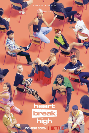 Group shot of young adults sitting on chairs against a vibrant orange backdrop for 'Heartbreak High' on Netflix, a coming-of-age series.