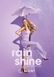 A smiling blonde woman holding a light purple umbrella against a split purple background with water spraying across one side.
