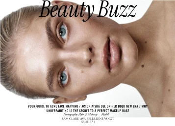 Close-up beauty portrait of a woman with blue eyes, textured skin, and natural makeup against a white backdrop.