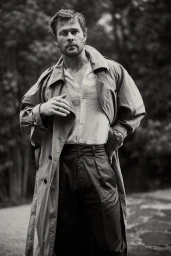 Monochrome portrait of Chris Hemsworth wearing an unbuttoned shirt and trench coat produced by Johanna Sinclair