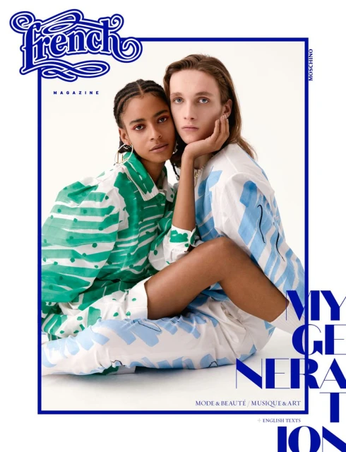 Fashion magazine cover with two models, one with braided hair in a green patterned top and the other with long brown hair in blue.