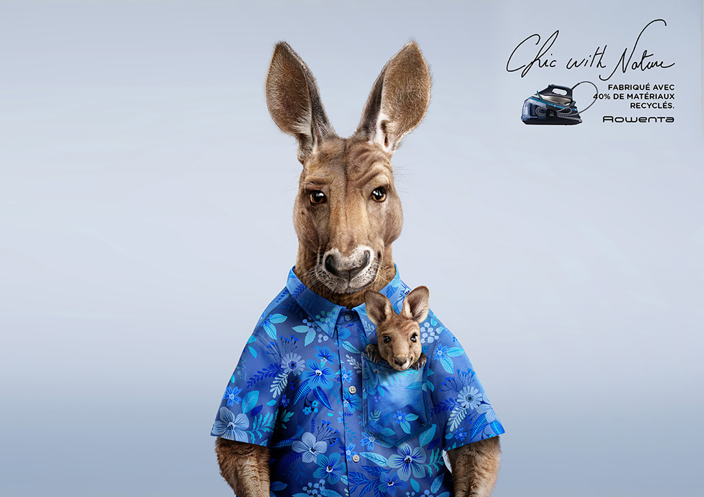 Anthroomorphic kangaroo wearing a blue floral shirt, with a joey in the pocket, set against a light blue background. Product advertising.