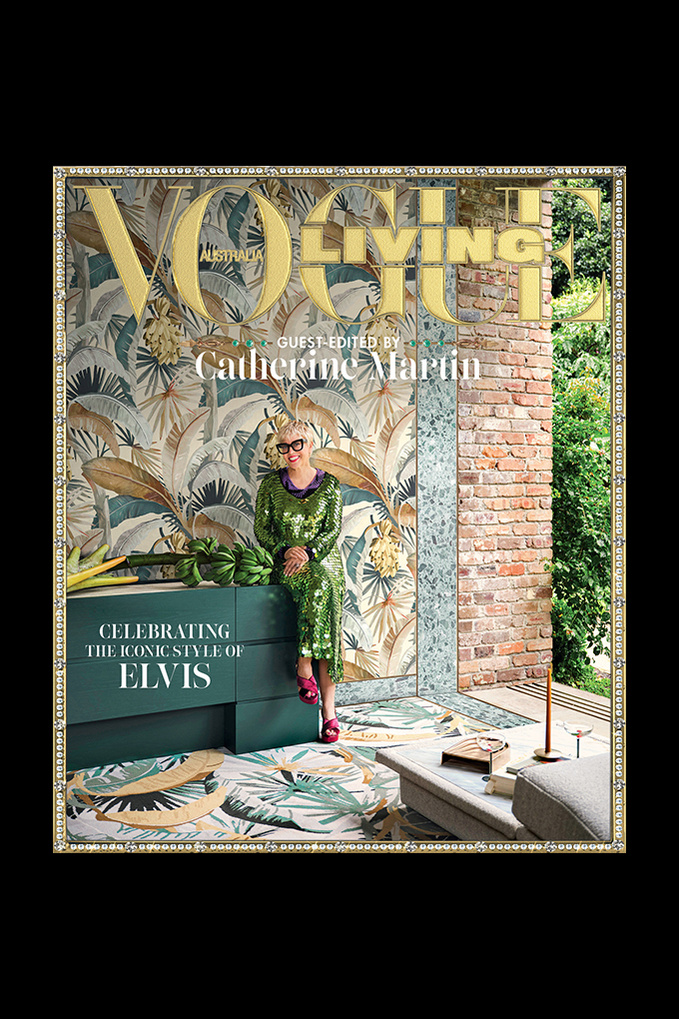 Vogue Living cover featuring Catherine Martin sitting on a teal bureau in a green sequin dress, surrounded by tropical-themed decor.