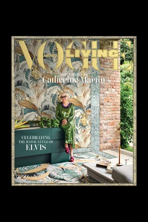Vogue Living cover featuring Catherine Martin sitting on a teal bureau in a green sequin dress, surrounded by tropical-themed decor.
