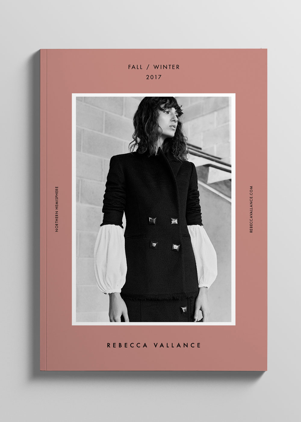 Fashion book cover featuring a monochrome image of a model in a black blazer and white puff-sleeve shirt against a brick wall backdrop.