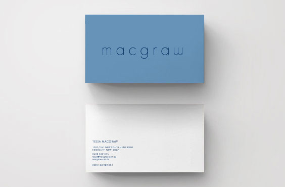 Minimalist business cards in light blue and white, featuring the name 'macgraw' and contact details on a clean, bright background.