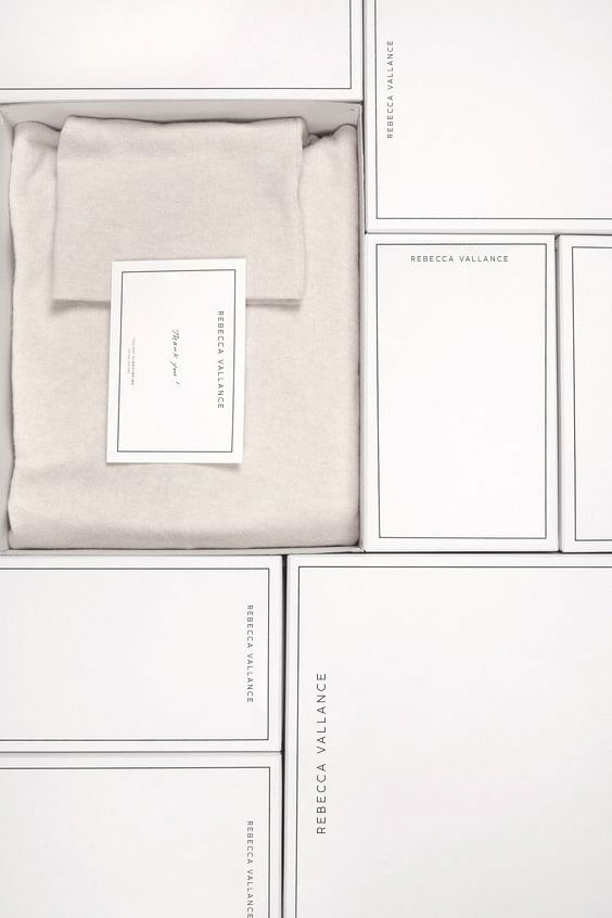 White boxes with product, neatly arranged. Clean product shot with visible brand label and complementary design card included.