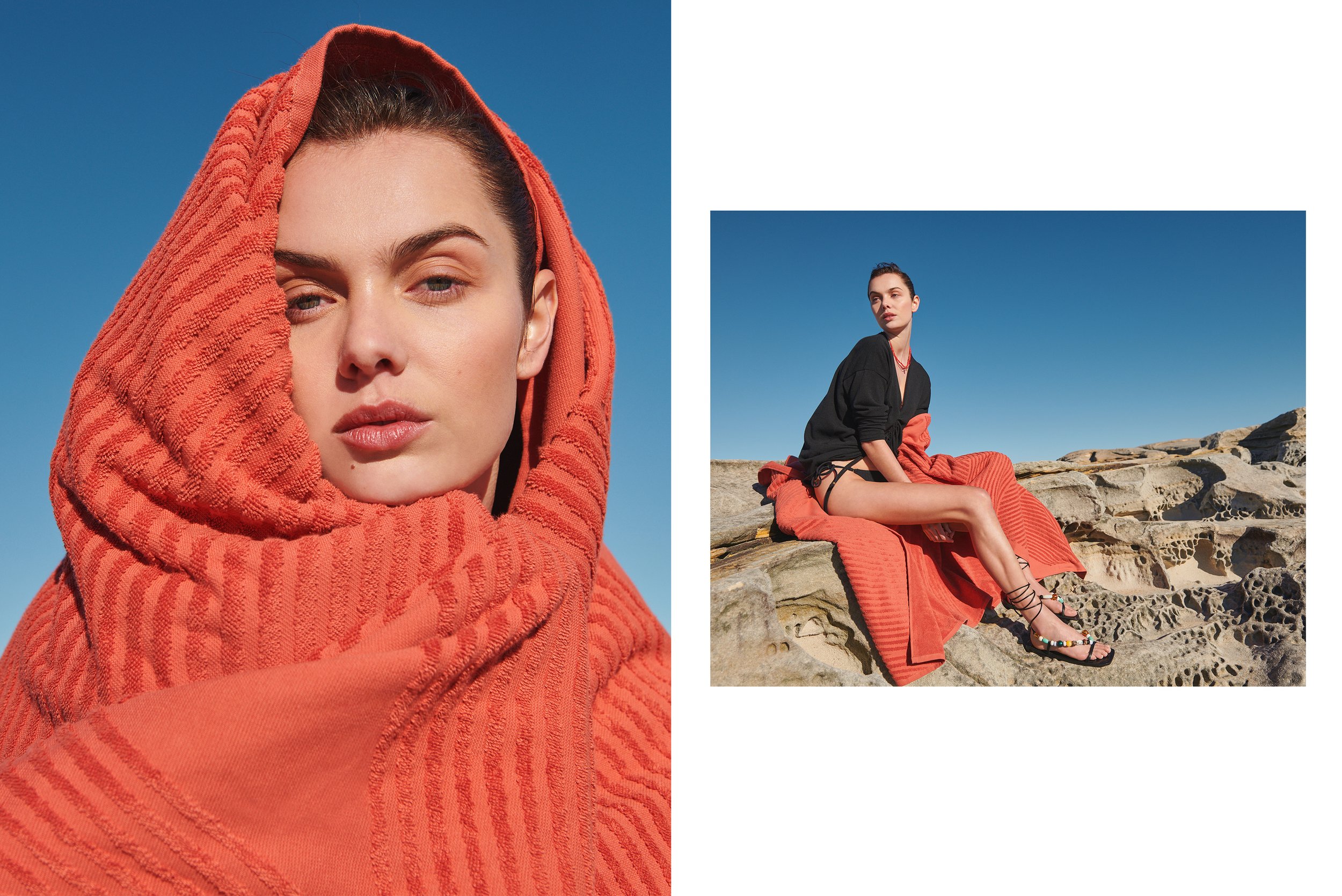 A woman with a towel over her head poses in natural sunlight against a blue sky, also seated on rocks draped with a towel.