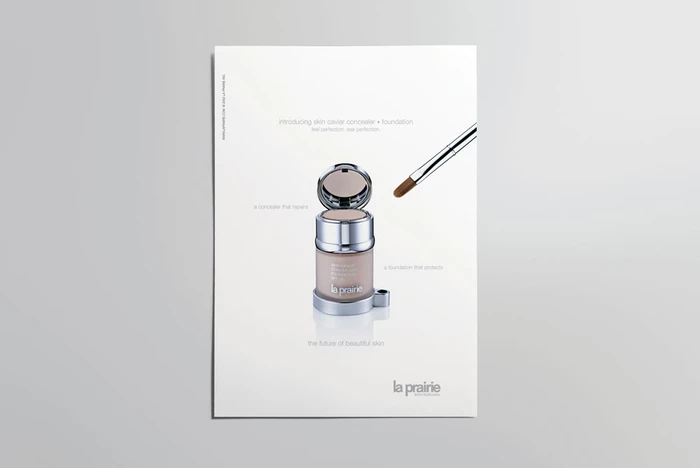 Cosmetic jar with an open compact lid and a makeup brush angled beside it against a clean white background.