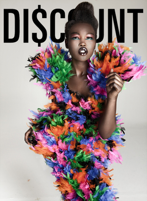 Fashion editorial shot of an adult Black woman in a colorful feather dress against a neutral backdrop with 'DISCOUNT' text overlay.