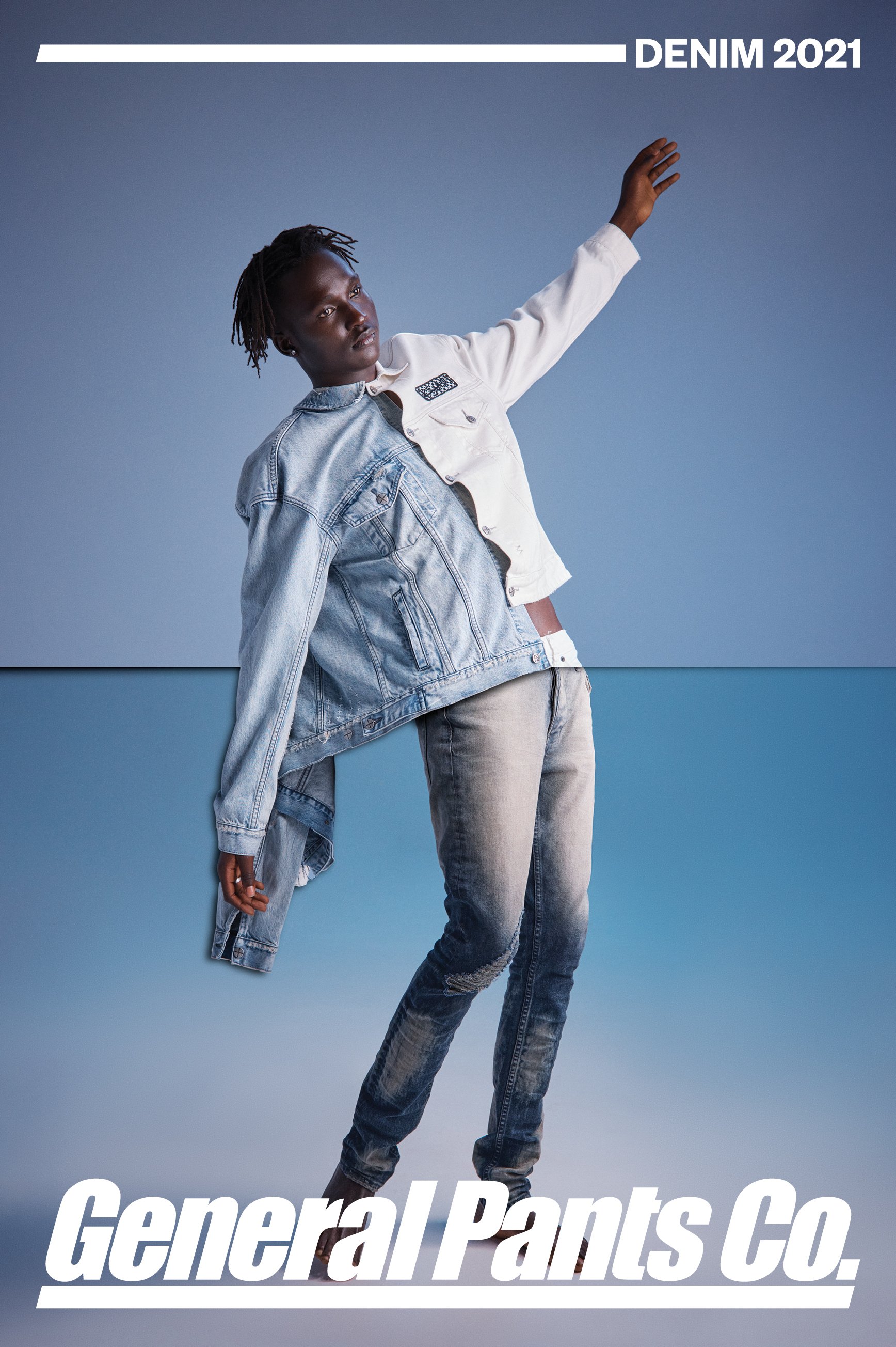 Fashion-forward denim concept featuring a Black male model showcasing a split denim and white jacket, paired with denim pants, against a blue backdrop.