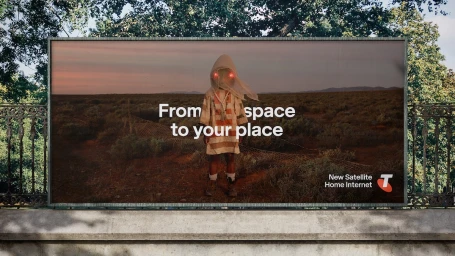 Billboard displaying a figure in a striped tunic standing in an arid landscape with glowing red eyes and overlaid text.