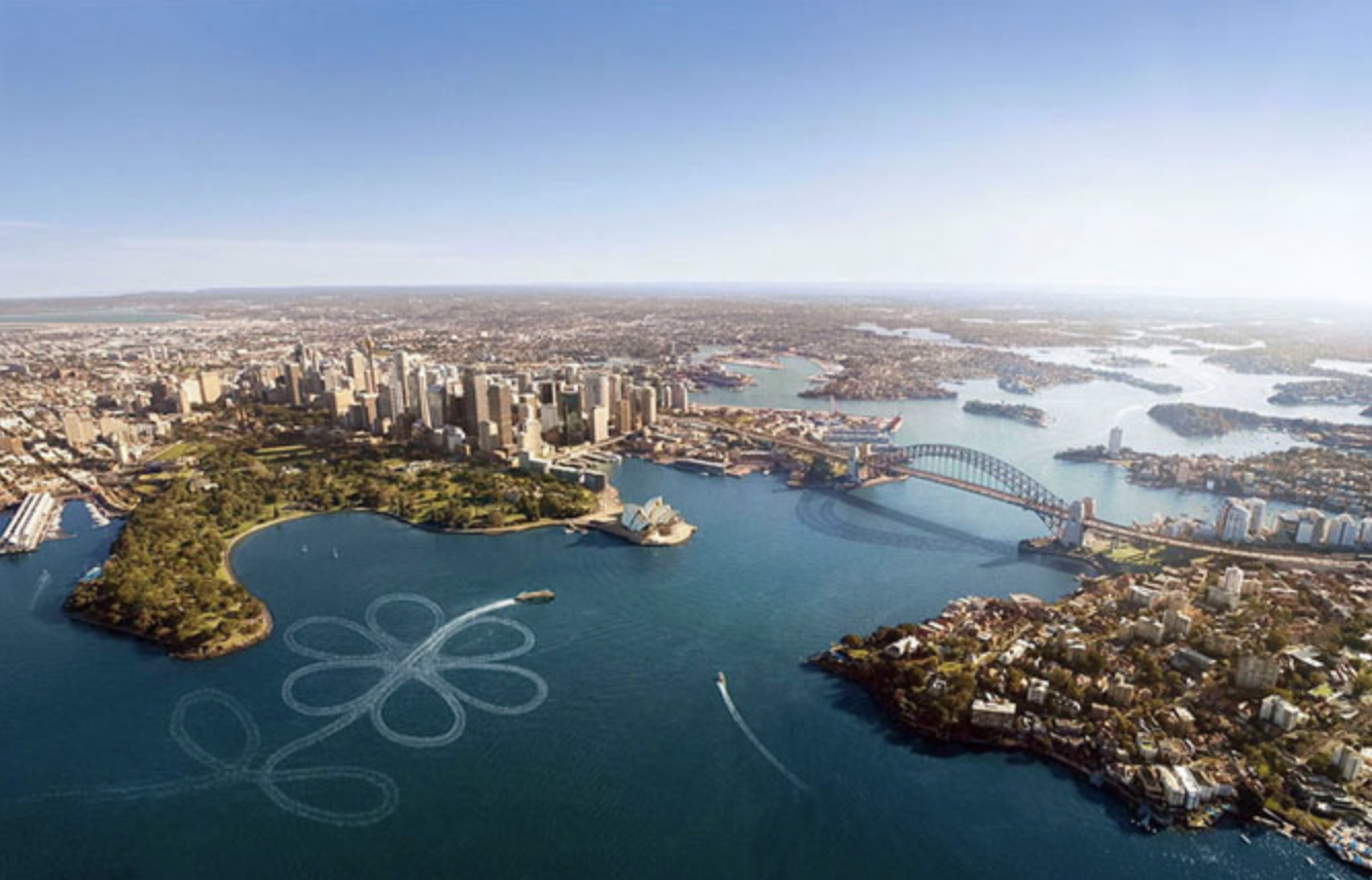 Aerial view of Sydney Harbour, featuring the Opera House, Harbour Bridge, city skyline, and a plane drawing a flower in the sky.