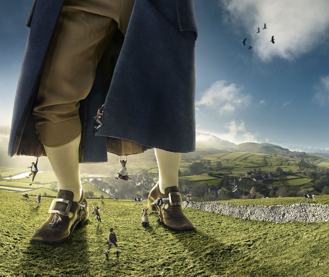Fantasy image of a giant and miniature people on a grassy hillside beneath a blue sky. Features large legs, period shoes, and miniature humans.