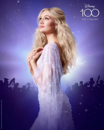 Elegant woman in a sparkling gown poses against a dreamy purple and blue background with Disney 100 concert details.