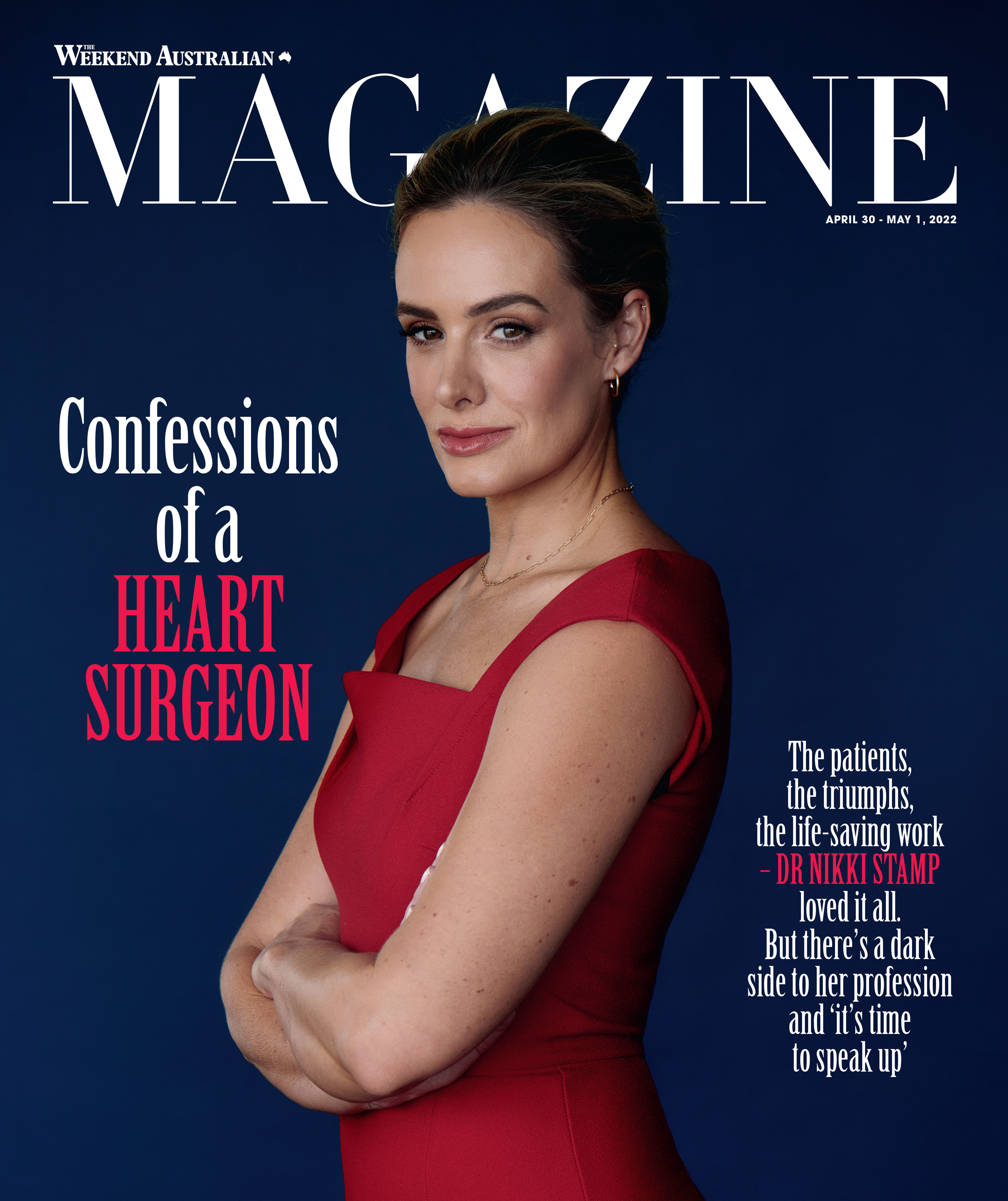 Magazine cover featuring a confident woman with crossed arms, wearing a red dress against a dark blue backdrop.