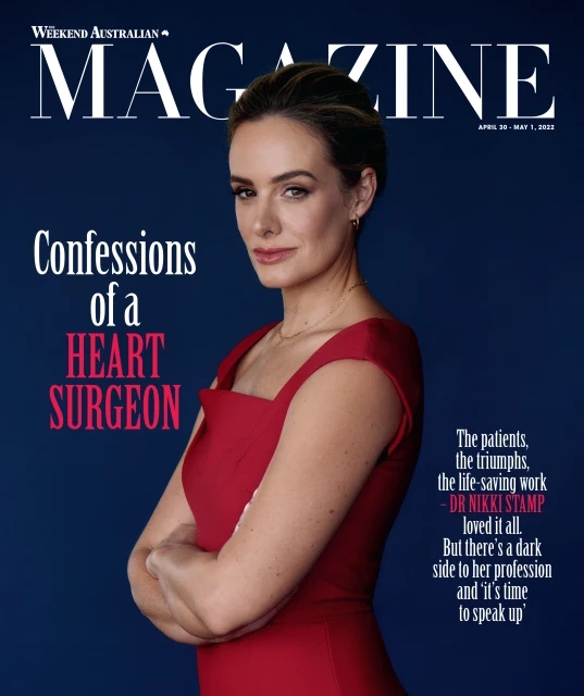 Magazine cover featuring a confident woman with crossed arms, wearing a red dress against a dark blue backdrop.