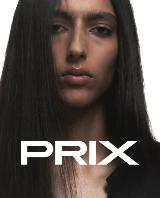 Close-up portrait of a person with long dark hair against a clean white background, featuring the word 'PRIX' in bold white letters.