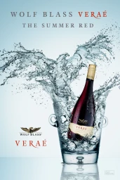 Wine bottle in an ice bucket surrounded by splashing water against a bright blue gradient background