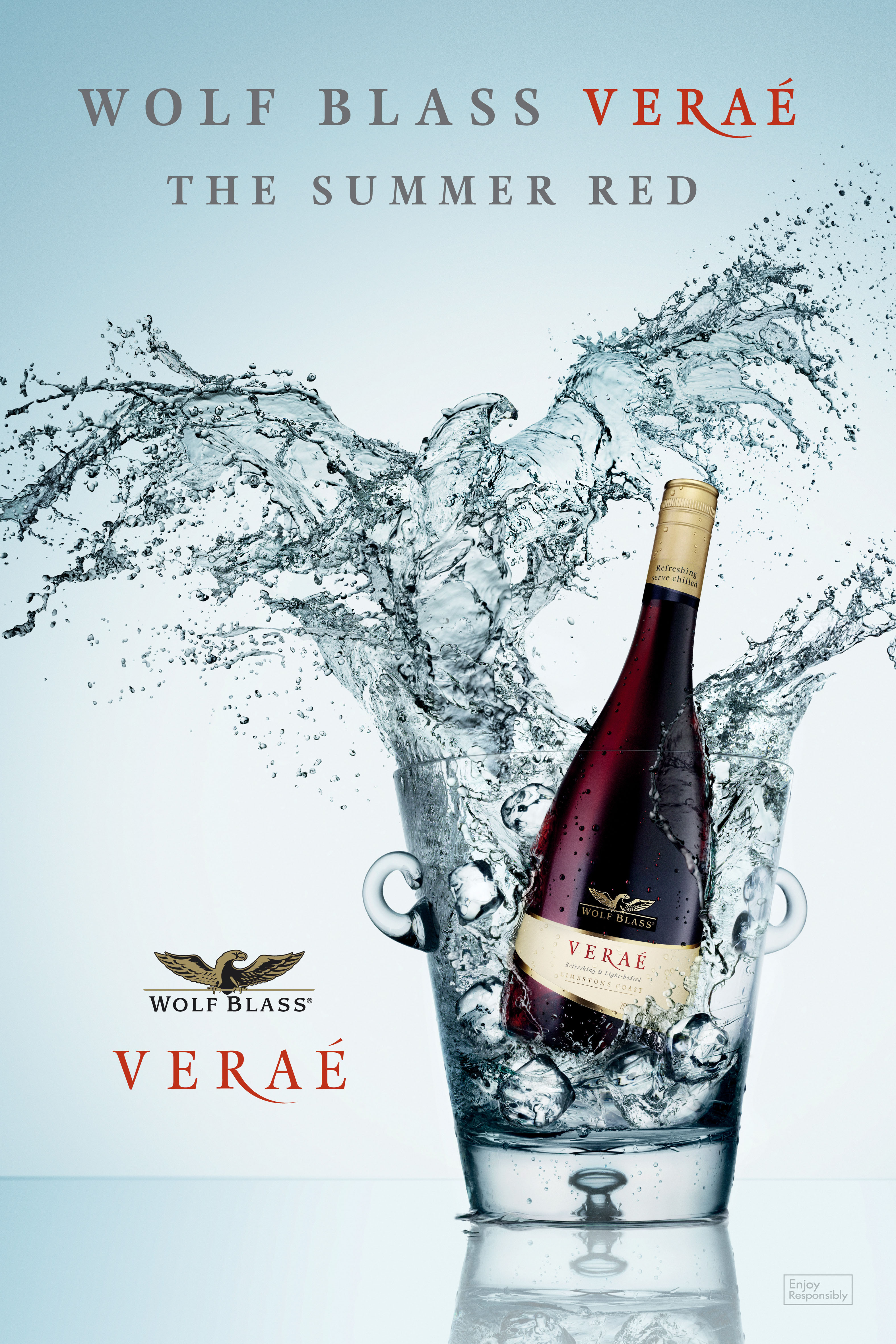Bottle of Wolf Blass Verae wine in an ice bucket with water splashing. Product photography with a bright, clean background.