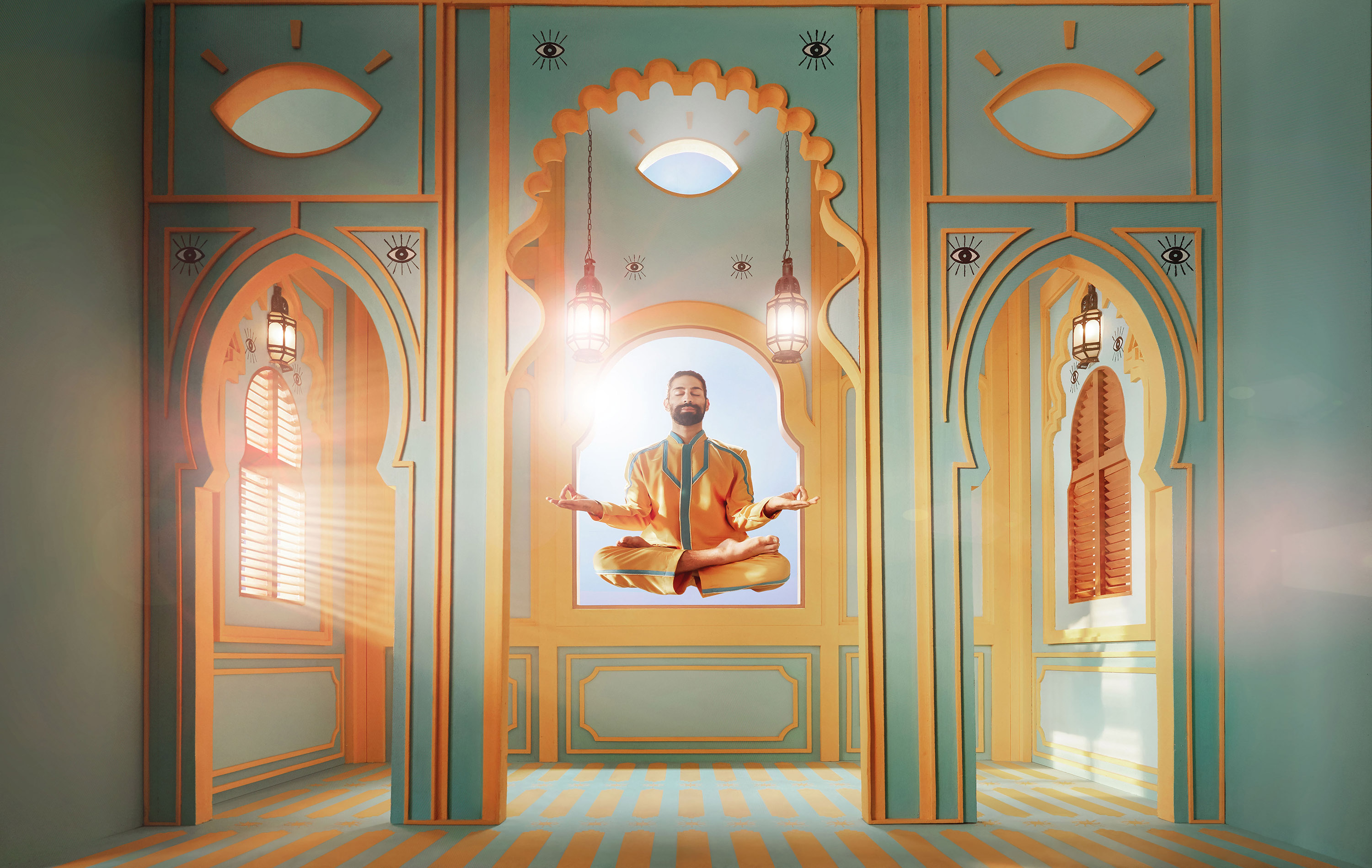 Adult male levitating in lotus position within ornamented, light-filled interior featuring arched doorways and decorative wall designs.