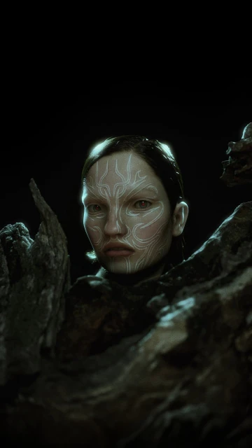 Portrait of a woman with face paint partially obscured by a textured, dark brown material against a dark background in a close-up shot.