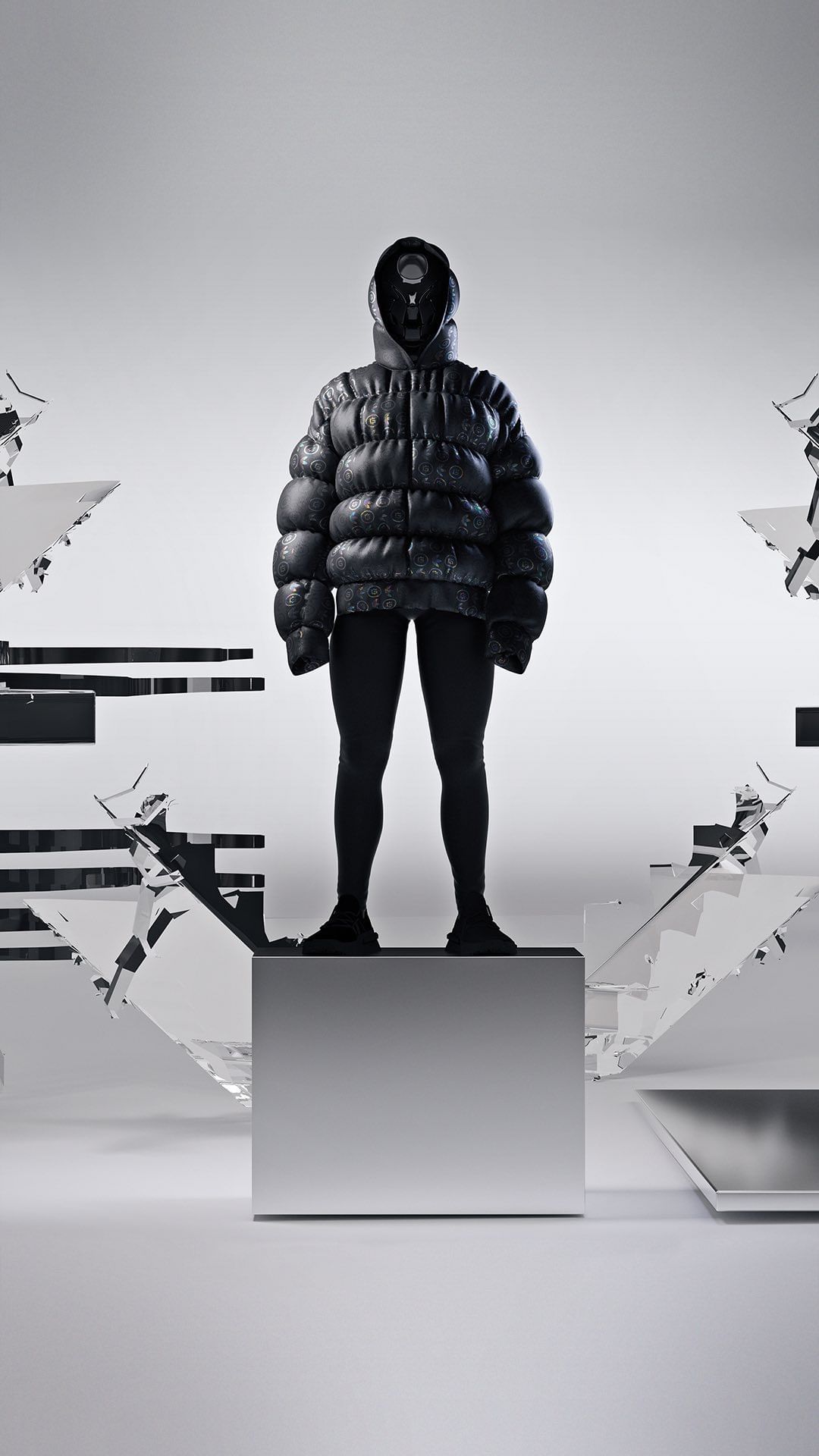 Full shot of androgynous figure in an oversized black puffer jacket and pants standing on a silver platform against a light gray background.
