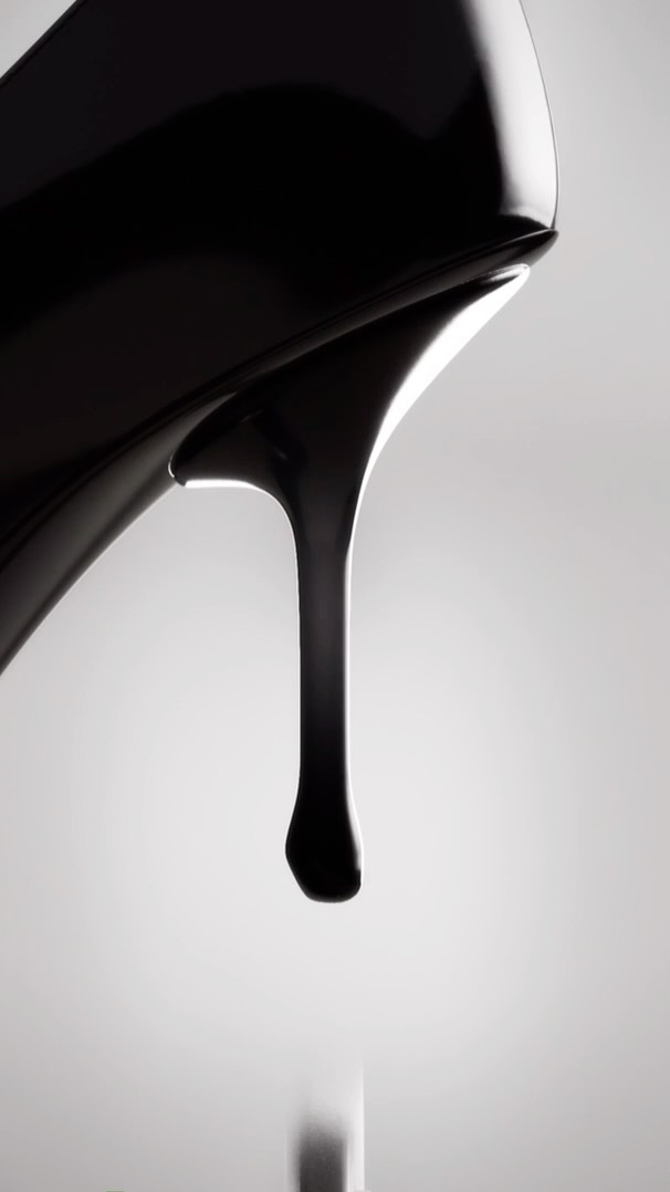 Close-up of a shiny black high-heel shoe with black liquid dripping from the heel against a gradient gray background.