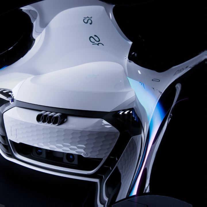 Futuristic white Audi concept car with sleek lines and a hexagonal grille design against a dark background, highlighting automotive innovation.