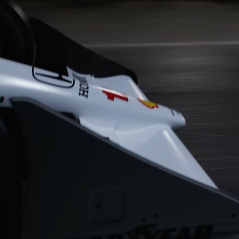 Close-up captures a Formula 1 race car speeding on the track, showcasing its aerodynamic design, sponsor logos, and the blur of motion.
