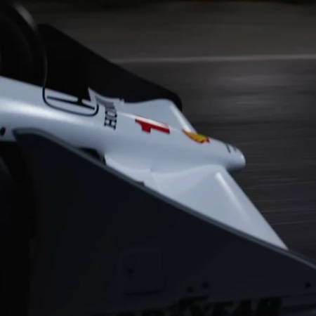 Close-up captures a Formula 1 race car speeding on the track, showcasing its aerodynamic design, sponsor logos, and the blur of motion.