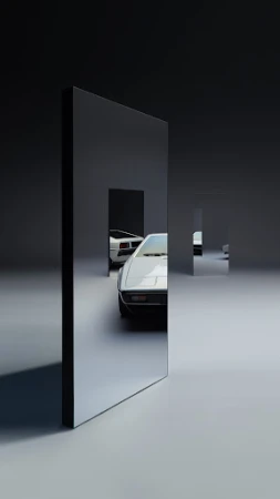 Two vintage cars are visible through rectangular mirrored panels in a minimalist automobile studio with dark grey and light grey surfaces.