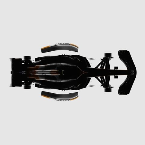 High angle view of a black, white, and orange race car with visible tires against a light gray studio background. Automotive concept.