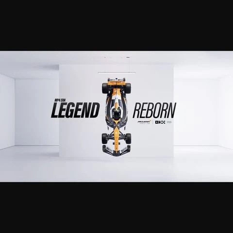 Front view of a black and gold McLaren Formula 1 race car in a white studio, next to the words 'MP4 Era Legend Reborn'.