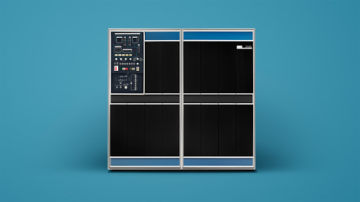 Vintage computer mainframe with black panels and blue trim against a blue background, showcasing retro technology and minimalist design.