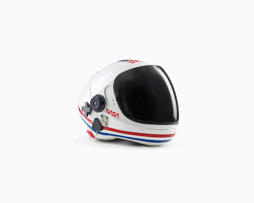 Astronaut helmet on a white background. Protective headgear with a dark visor, stripes, and a NASA logo suitable for space travel.