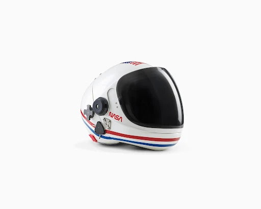 Astronaut helmet on a white background. Protective headgear with a dark visor, stripes, and a NASA logo suitable for space travel.